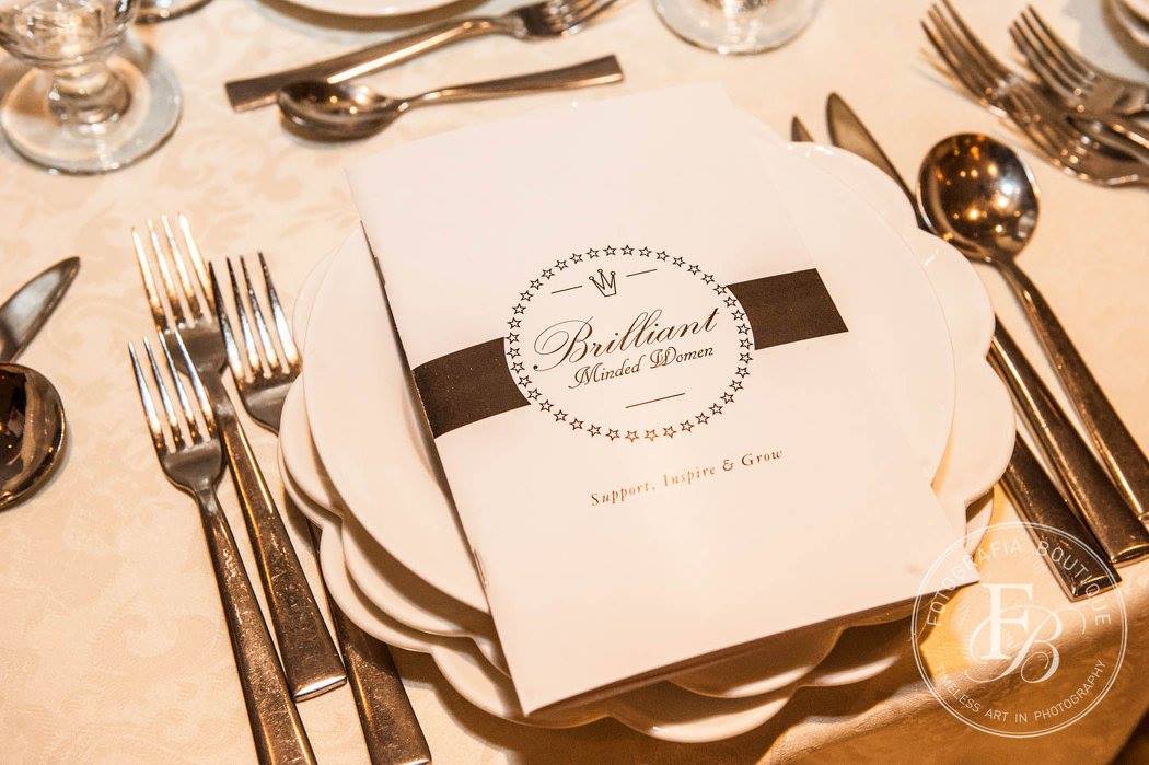 Brilliant Minded Women event program card on a table setting